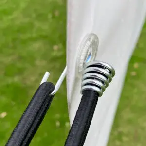 Gooseneck bungee loop securing an outdoor advertising banner to a metal frame.
