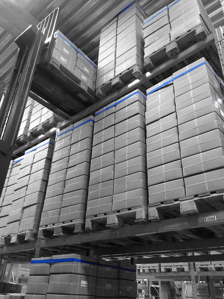 Pallets secured with large rubber bands for internal storage in warehouse